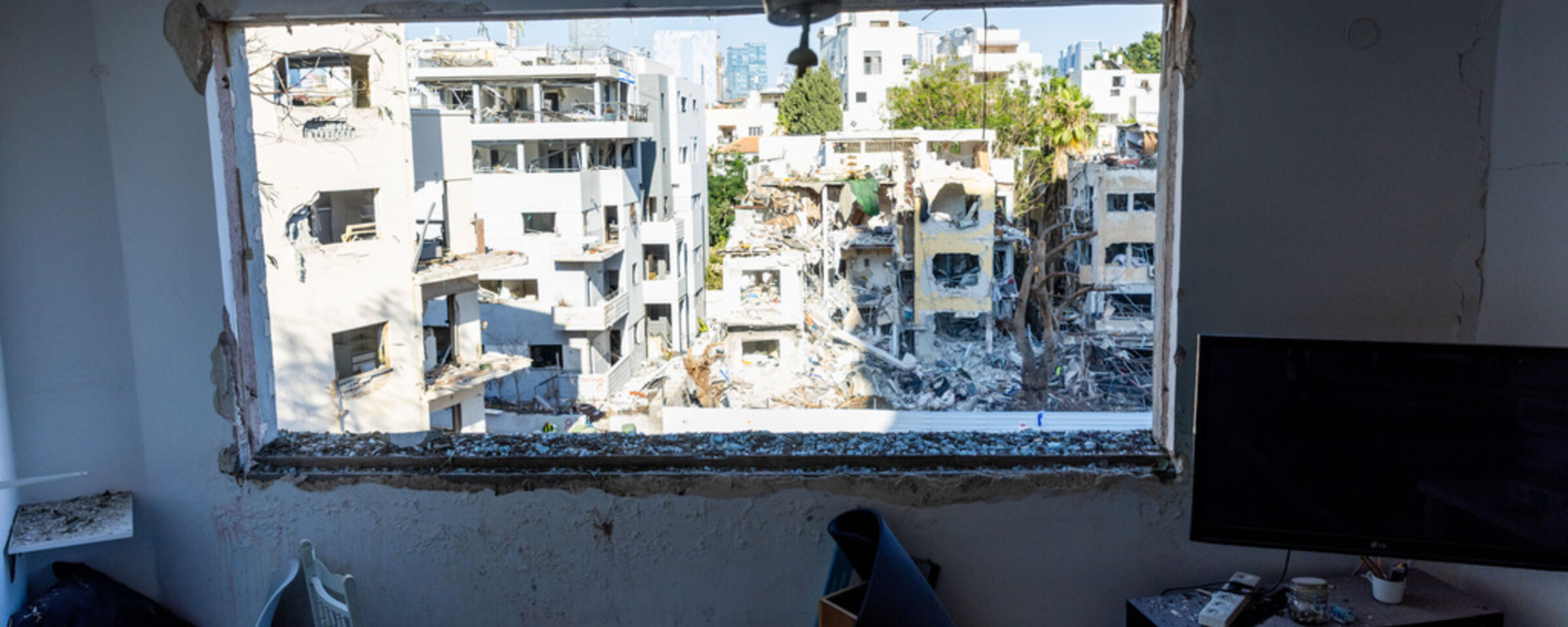 A view of devasted buildings, looking out through a window