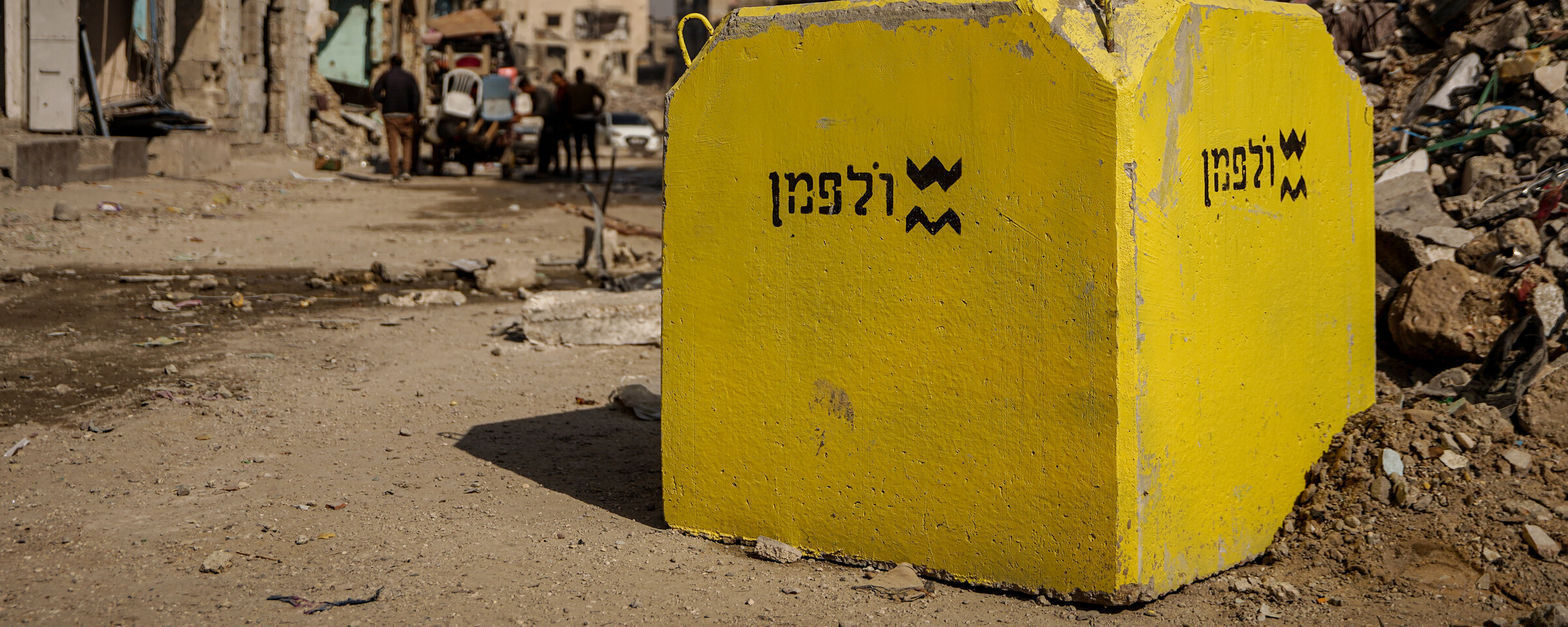 Large yello concrete block seen among ruins