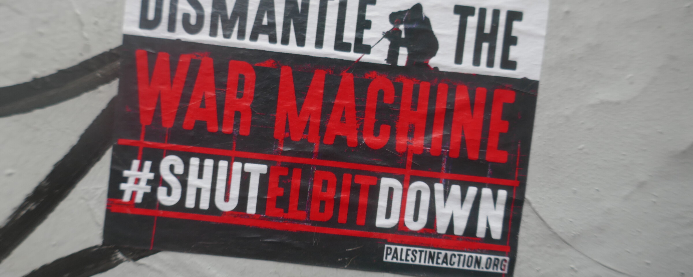 A poster reading Dismantle the War Machine Shut Elbit Down 