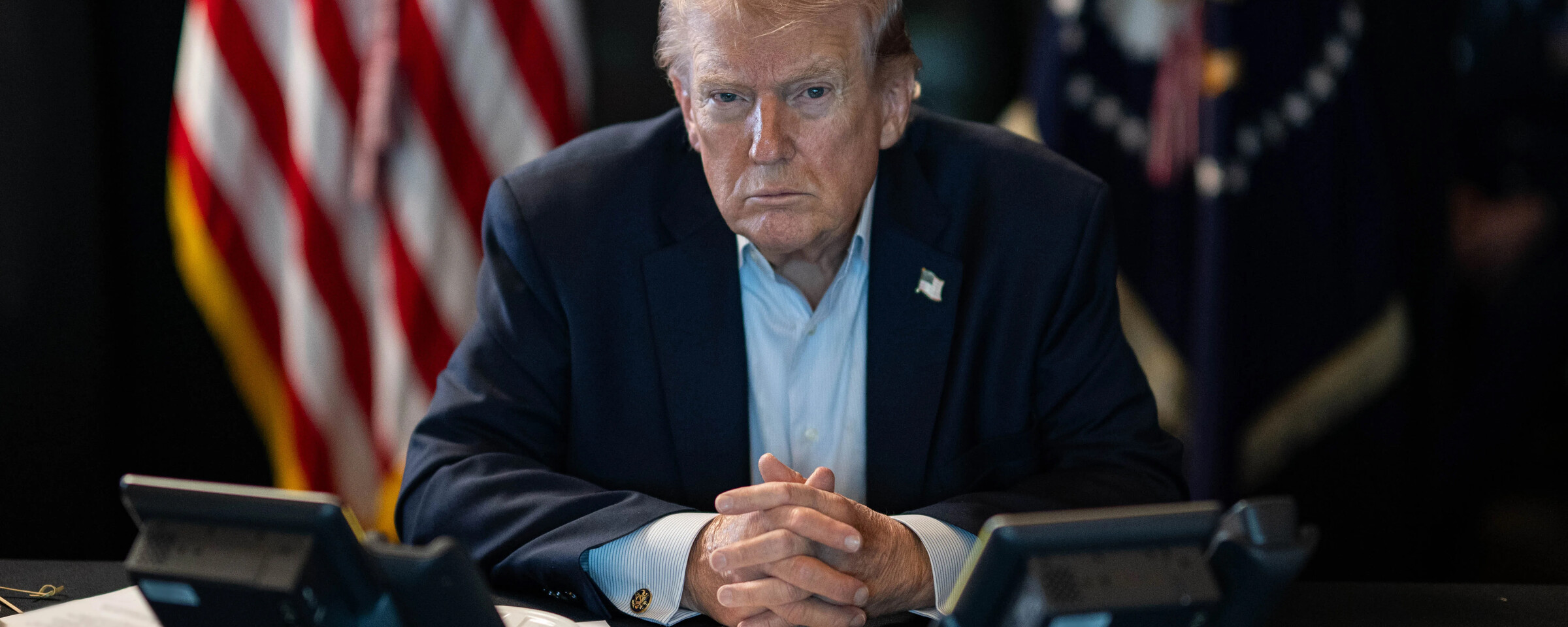 Trump at desk with telephones in front of him