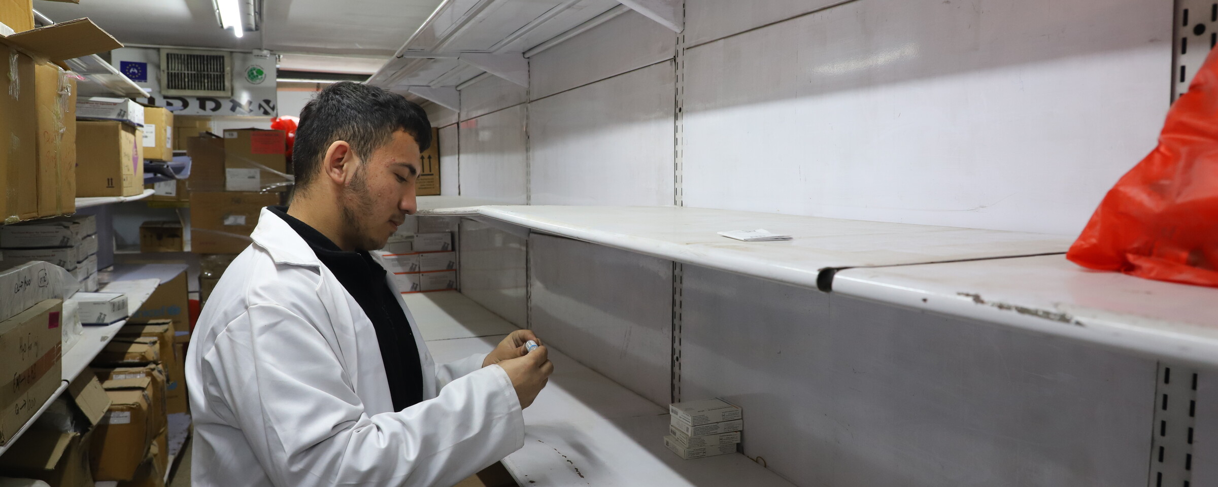 A man searches empty shelves