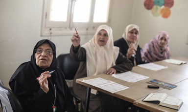 Palestinian women in Gaza in a classroom participating in reading lessons