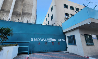 A gate - painted blue and topped with barbed wire - at the Gaza headquarters of the UN agency for Palestine refugees