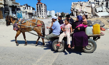 A family on a donkey-drawn cart leaving Jabaliya camp 