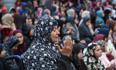 A crowd of women pray 