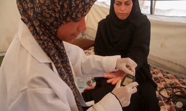 A nurse takes blood pressure from a pregnant woman