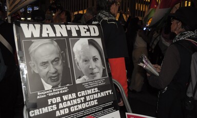 a poster decrying the war crimes of Netanyahu and Biden Harris