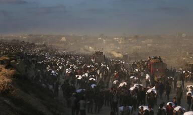 A crowd surges around aid trucks in northern Gaza