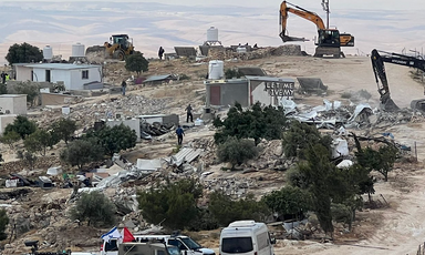 Bulldozers tear through a small village