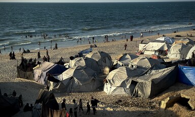 Makeshift tents laid out on the shore