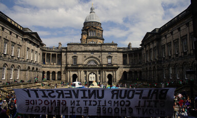 Protest at University of Edinburgh with a banner seen from the back emblazoned with "Balfour's University"