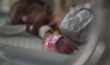 Close-up of the hand of a baby with a breathing tube