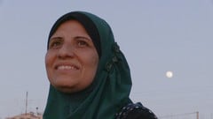 Smiling woman wearing hijab towards sky
