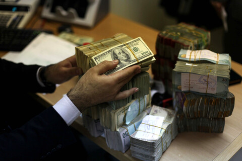 Close-up of hands handling stacks of various paper curreincies