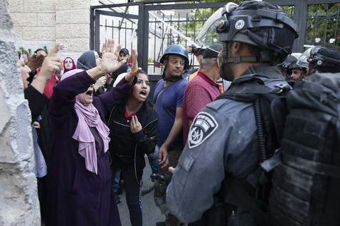 Women confront soldiers near gate 