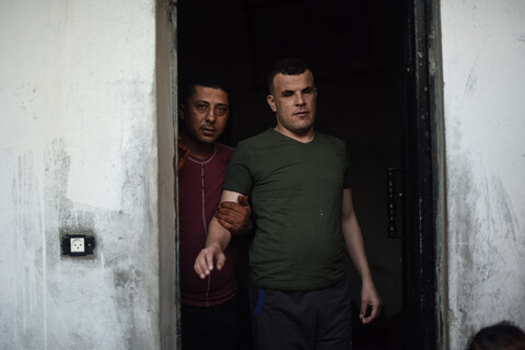 Man guides another man who is visually impaired