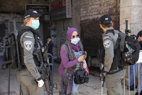 Woman standing between two soldiers 