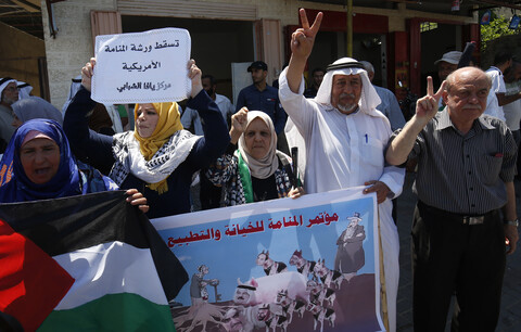 People hold up banners during a demonstration