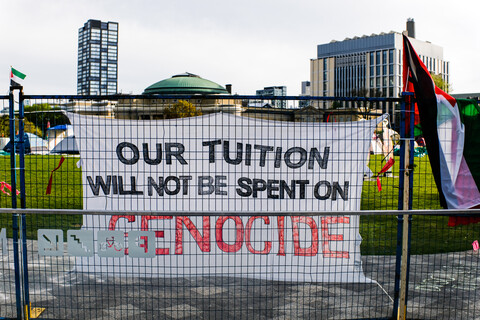 A sing reads: Our tuition will be spent on genocide