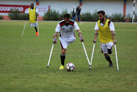 Footballers on crutches at play