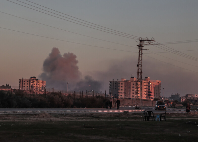 in the distance smoke plumb fills sky with residential towers on the right 