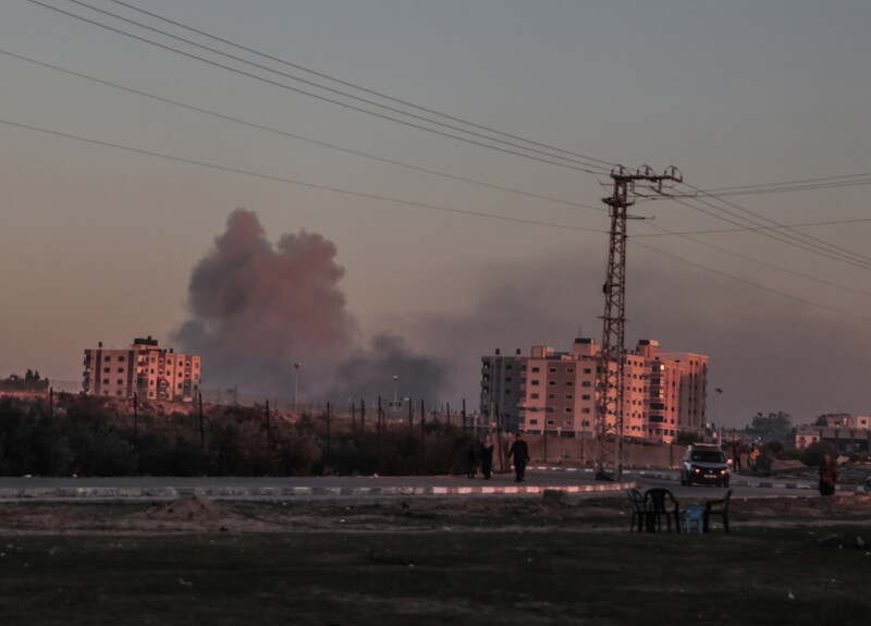 in the distance smoke plumb fills sky with residential towers on the right