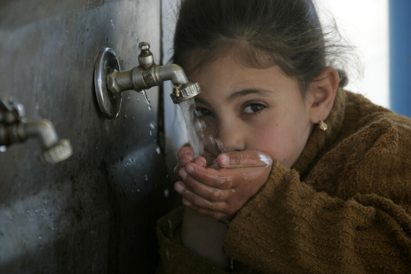 Girl drinks water from tap