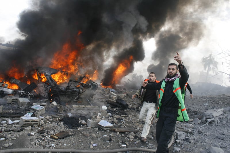 Emergency workers run alongside burning debris