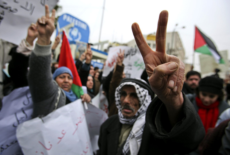 Palestinians flash &quot;v&quot; for victory symbol at Khader Adnan rally