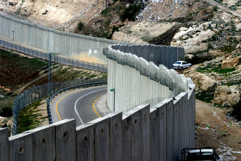 Aerial view of Israel's wall in the West Bank with a settler road along one side