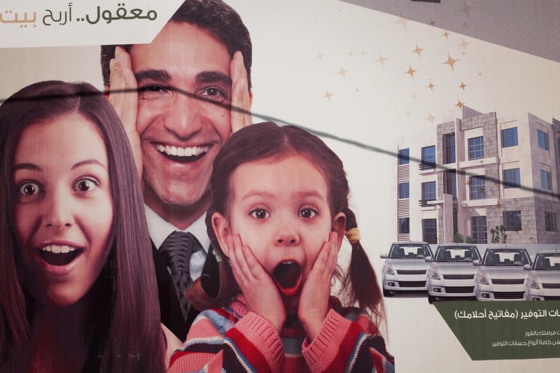 Image of billboard depicts idealized family which owns several cars