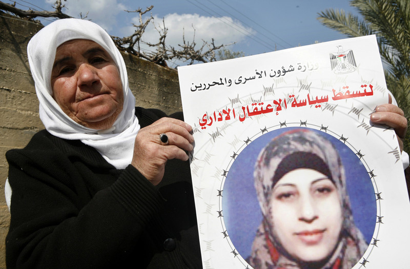 Badia al-Shalabi displays poster of her daughter