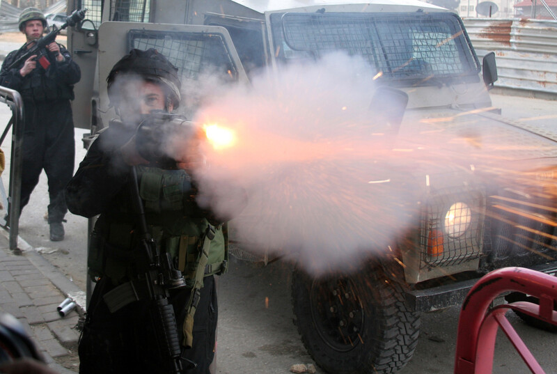 Israeli soldier fires tear gas cannister