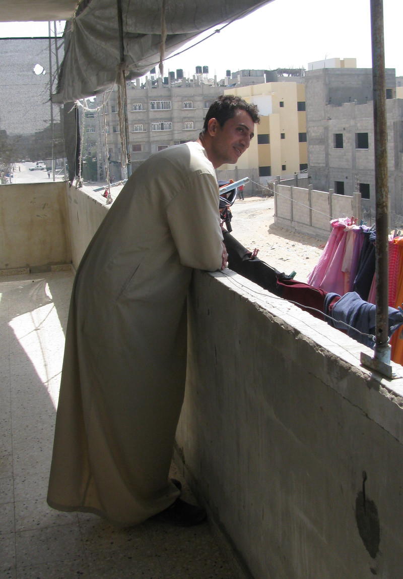 Raed Abu al-Zomar on his balcony overlooking a housing project