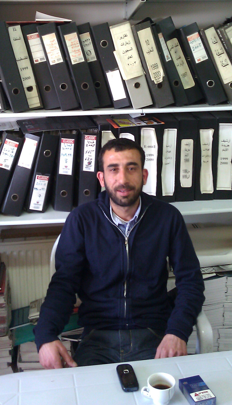 Mourad Jadallah sits in front of book shelf