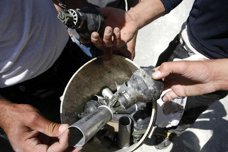 Men display tear gas cannisters