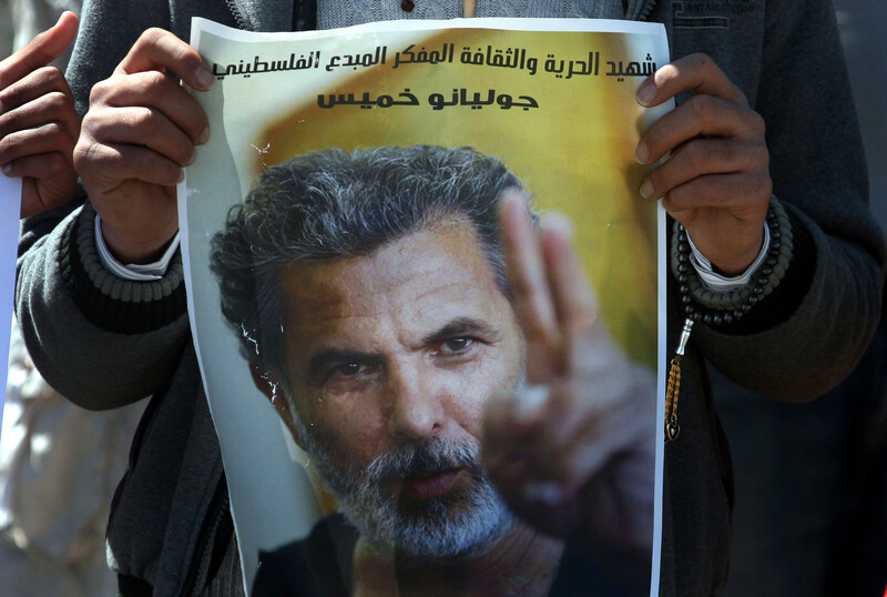 Man displays poster of Juliano Mer Khamis