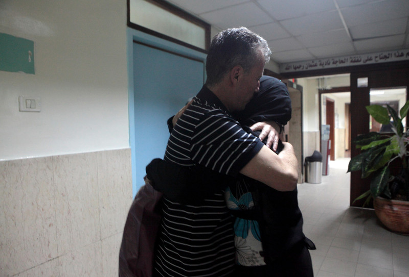 Bassem Tamimi hugs his wife in hallway