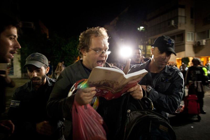 Police arrest man reading from book