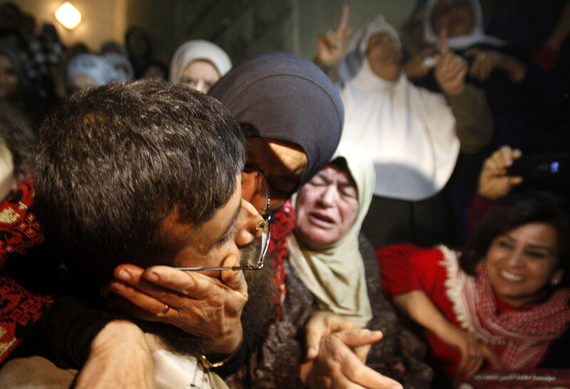 Woman kisses Khader Adnan on cheek as well-wishers look on