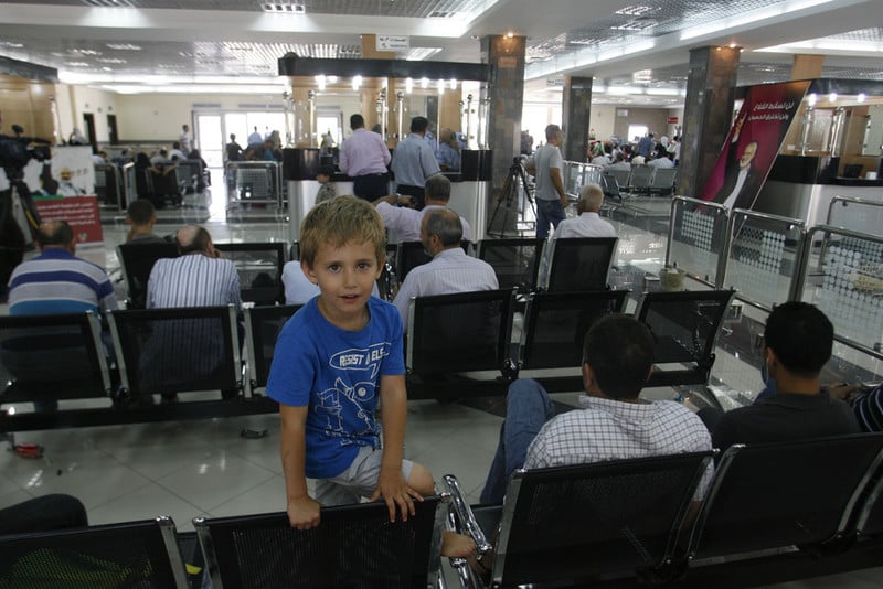 Palestinians wait at the Rafah border crossing to travel from Gaza to Egypt