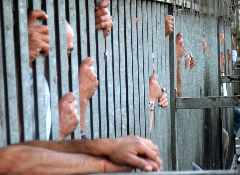 Palestinian workers line up at an Israeli checkpoint near Bethlehem
