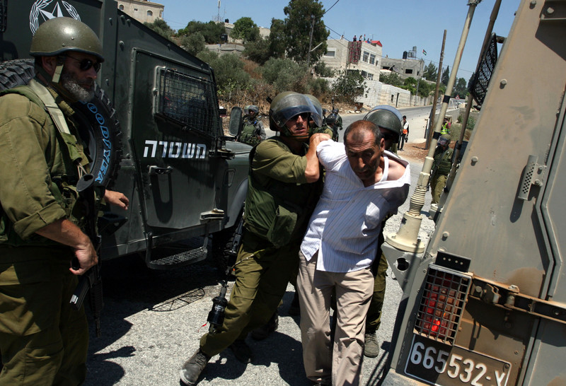 Armed Israeli soldiers arrest unarmed Palestinian man