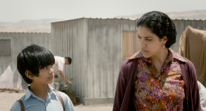 Boy and woman in desert refugee camp