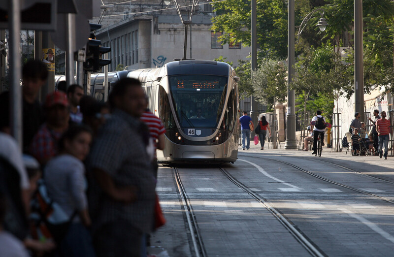 Passengers wait as light rail train approaches