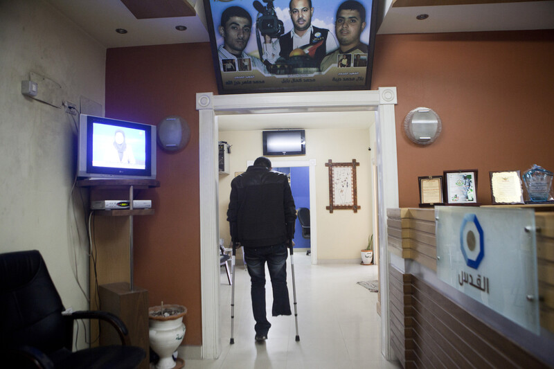 Man walks with crutches with his back turned to the camera