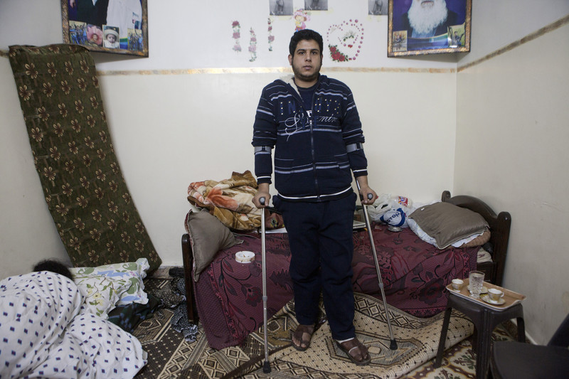 Man using crutches stands in his residence
