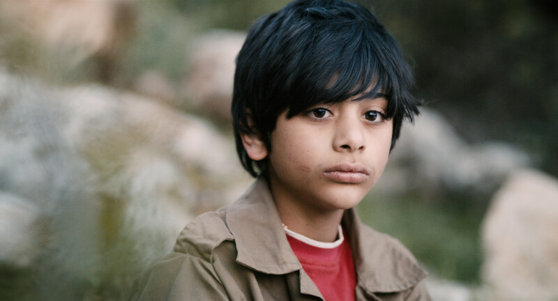 Close-up of boy with dirty face and disheveled hair