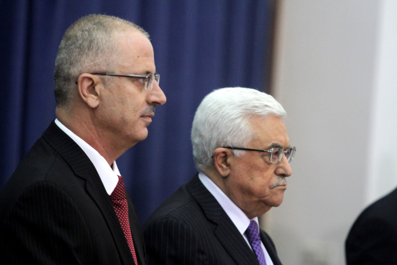 Close-up of profiles of Dr. Rami Hamdallah and Mahmoud Abbas