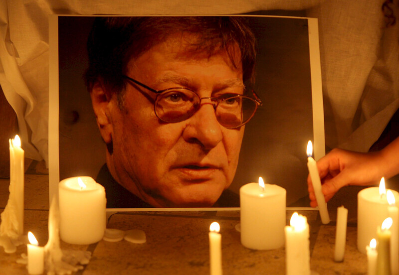 Portrait of Mahmoud Darwish illuminated by candles